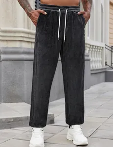 Detailed view of men's charcoal textured sports pants with white drawstring on model.