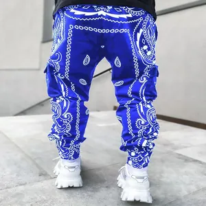 Back view of men's blue high-street harem cargo pants with white paisley print pattern