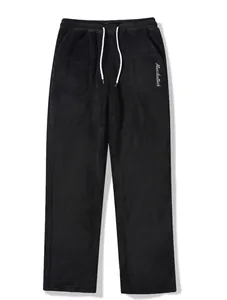 Close-up detail of men's black oversized fleece joggers featuring a white drawstring