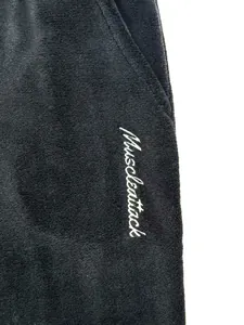 Detail view of premium black coral fleece fabric with Muscleattack embroidery on pocket