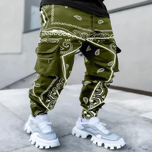 Olive green men's paisley cargo pants featuring multi-pockets and a harem fit style.