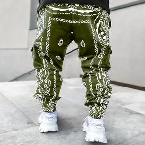 Close-up of men's olive green cargo pants with white bandana paisley print detail