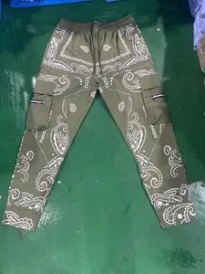 Detailed view of olive green paisley cargo joggers with side zip pockets and drawstring
