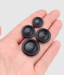 Close-up view of four different sized black high-end resin buttons for garments
