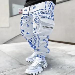 Close-up detail of men's white harem cargo pants featuring blue paisley print design