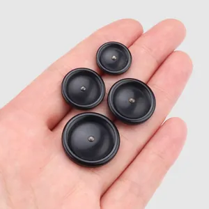 High-end black Japanese resin buttons for coats and jackets shown for scale in hand