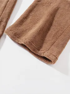Close-up detail of soft brown plush fleece fabric texture on men's winter tracksuit