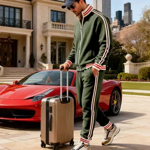 Men's green heavyweight tracksuit set with striped details in luxury lifestyle setting