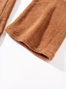 Macro detail of soft brown plush fabric and hem stitching on men's casual pants