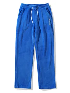 Close-up of blue men's fleece pants featuring white drawstring and embroidery.