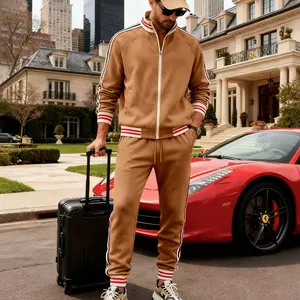 Close-up detail of men's tan fleece tracksuit with red and white striped cuffs
