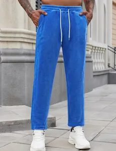 Detailed view of blue plush men's joggers with drawstring and embroidery detail