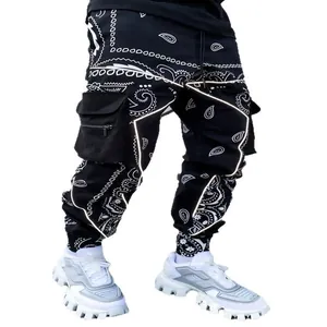 Men's high street paisley print joggers with cargo pockets and reflective stripes