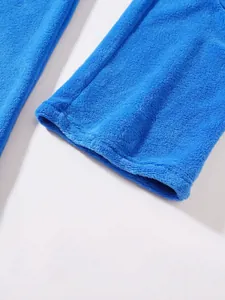 Detailed close-up of blue fuzzy fleece fabric on men's casual sports pants cuff