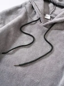 Macro view of grey fleece hoodie texture and neckline size label