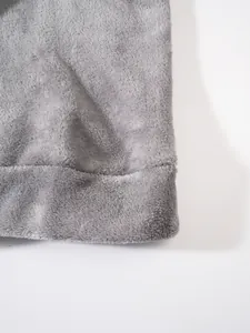 Detail macro view showing the soft grey fleece fabric texture of a men's winter tracksuit