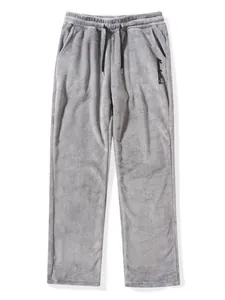 Close-up of grey plush joggers with drawstring waist and embroidered Muscleattack logo