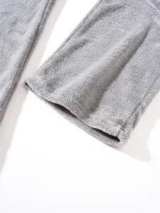 Detailed close-up showing the soft grey plush fleece material and hem of these joggers