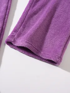 Detailed close-up showing the soft purple fleece fabric and hem of men's casual trousers.