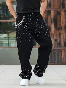 Loose straight black jeans for men featuring sparkling rhinestone studs and pearl chain detail