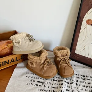 Detail view of warm fleece-lined winter snow boots for toddlers in beige and brown