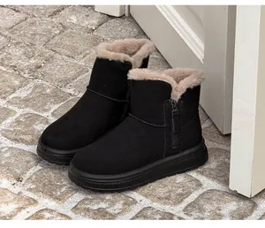 Black winter snow boots featuring warm faux fur lining and functional side zipper detail