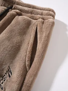 Macro view showing the soft fleece texture and pocket detail of men's casual pants