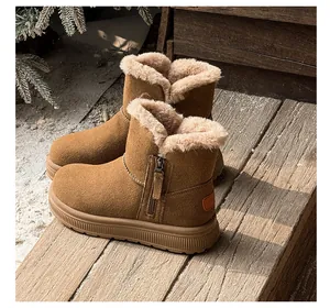 Detailed view of brown suede snow boots with warm faux fur lining and side zipper