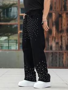 Trendy men's loose straight black denim jeans with decorative sparkling rhinestone studs