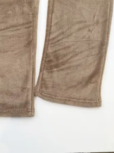 Detail shot of brown fleece lounge pants showing soft texture and double-stitched hem.