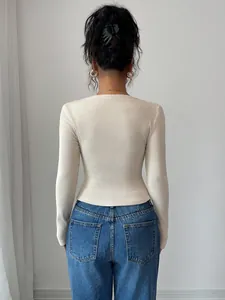 Back view of a chic cream-colored ribbed knit long-sleeve top for women in autumn.