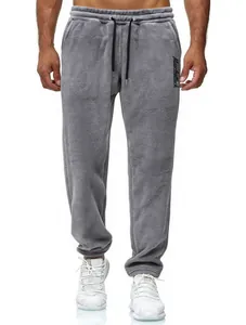Detailed view of men's grey fleece trousers on model showing texture and drawstring