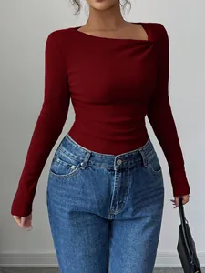 Detail view of burgundy ribbed knit top featuring unique asymmetrical neckline design