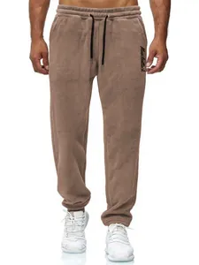 Detailed view of men's brown fleece sports joggers with drawstring and embroidery
