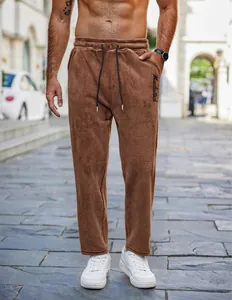 Full view of men's brown teddy fleece lounge pants featuring drawstring and embroidery