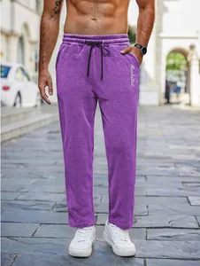 Detailed shot of purple men's leisure pants featuring a drawstring waist and side pockets.