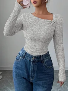 Detail of grey ribbed knit top with a stylish asymmetrical slanted neckline design.