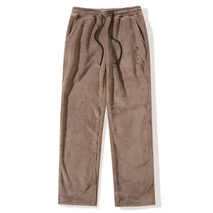 Detailed view of soft plush fabric and Muscleattack embroidery on men's casual pants