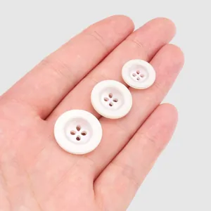 Premium white resin buttons in three sizes for high-end clothing and accessories
