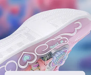 Close-up detail of pink girls sneakers showing heart and star patterns on the sole