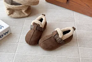 Detail view of brown suede children's shoes with warm fleece lining and stylish buckle.