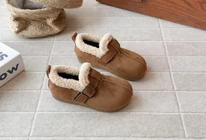 Close-up of cozy brown fleece-lined suede winter shoes for girls with buckle detail