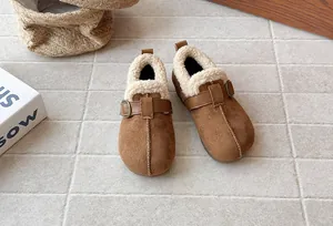 Detailed close-up of brown suede children's winter shoes featuring soft fleece lining