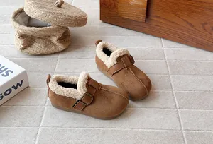 Detail view of brown suede children's fleece-lined clogs with metal buckle strap