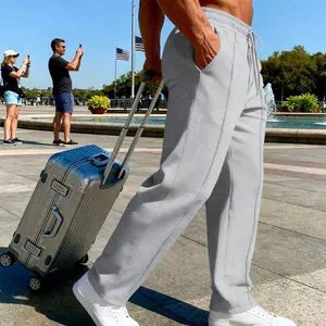 Detail view of grey men's joggers with drawstring waist in outdoor travel scene