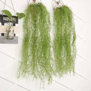 Macro view of lifelike artificial hanging air plant with green moss-like texture.
