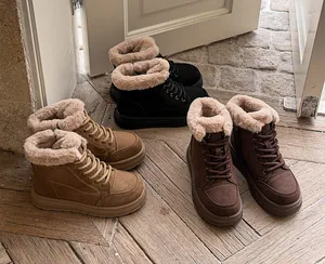 Macro view of three pairs of winter platform snow boots in brown, black, and tan colors.