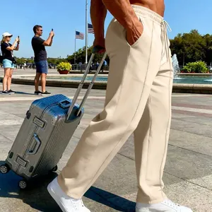 Close-up of men's beige knitted casual straight-leg pants with adjustable drawstring waist