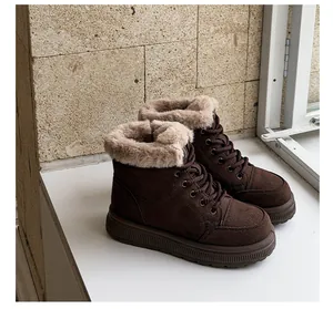 Detailed view of brown retro snow boots with thick soles and plush faux fur lining.
