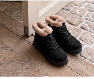 Detailed view of women's black thick-sole snow boots with warm faux fur lining